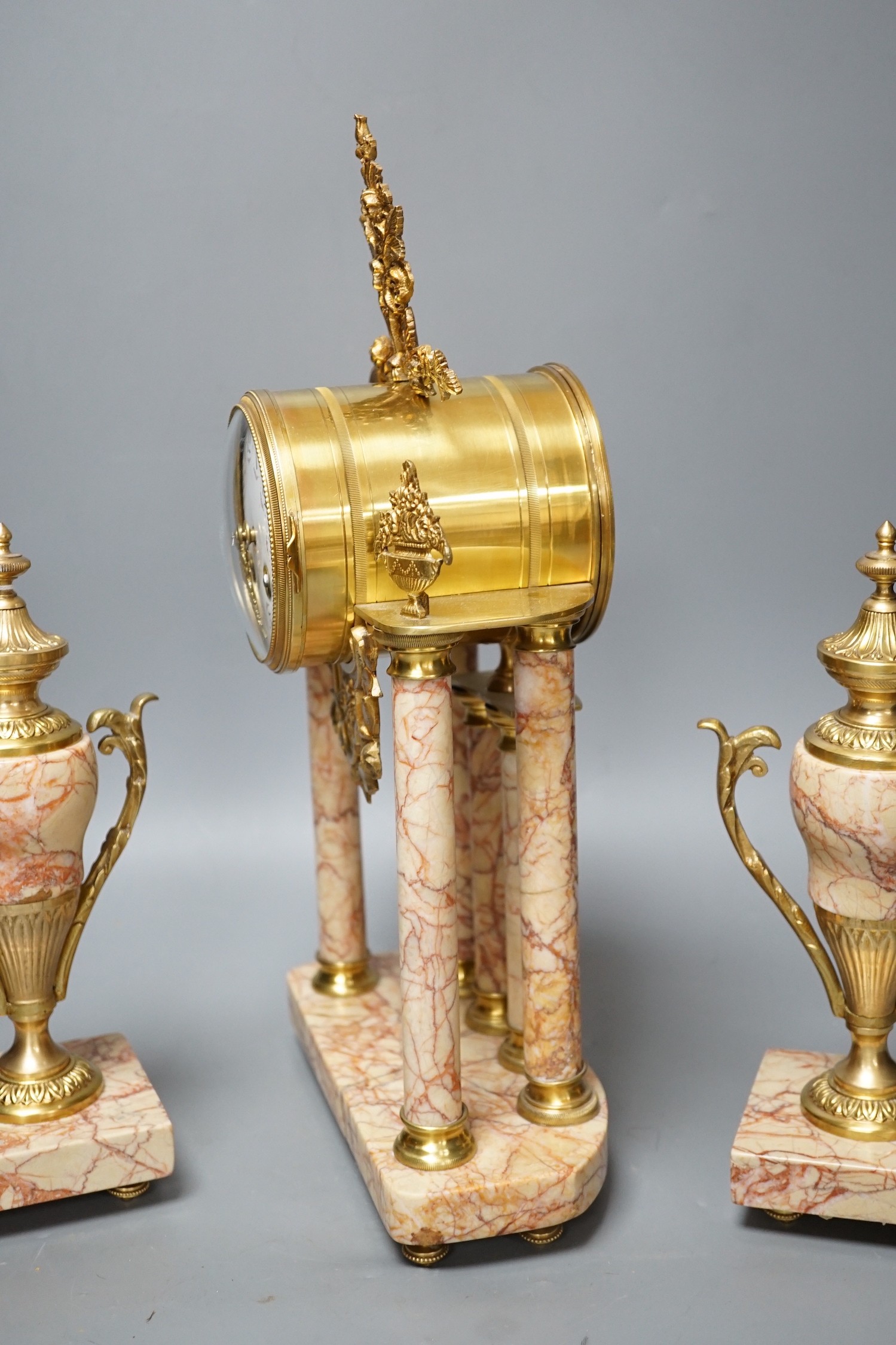 A French gilt metal and marble clock garniture, 38cm